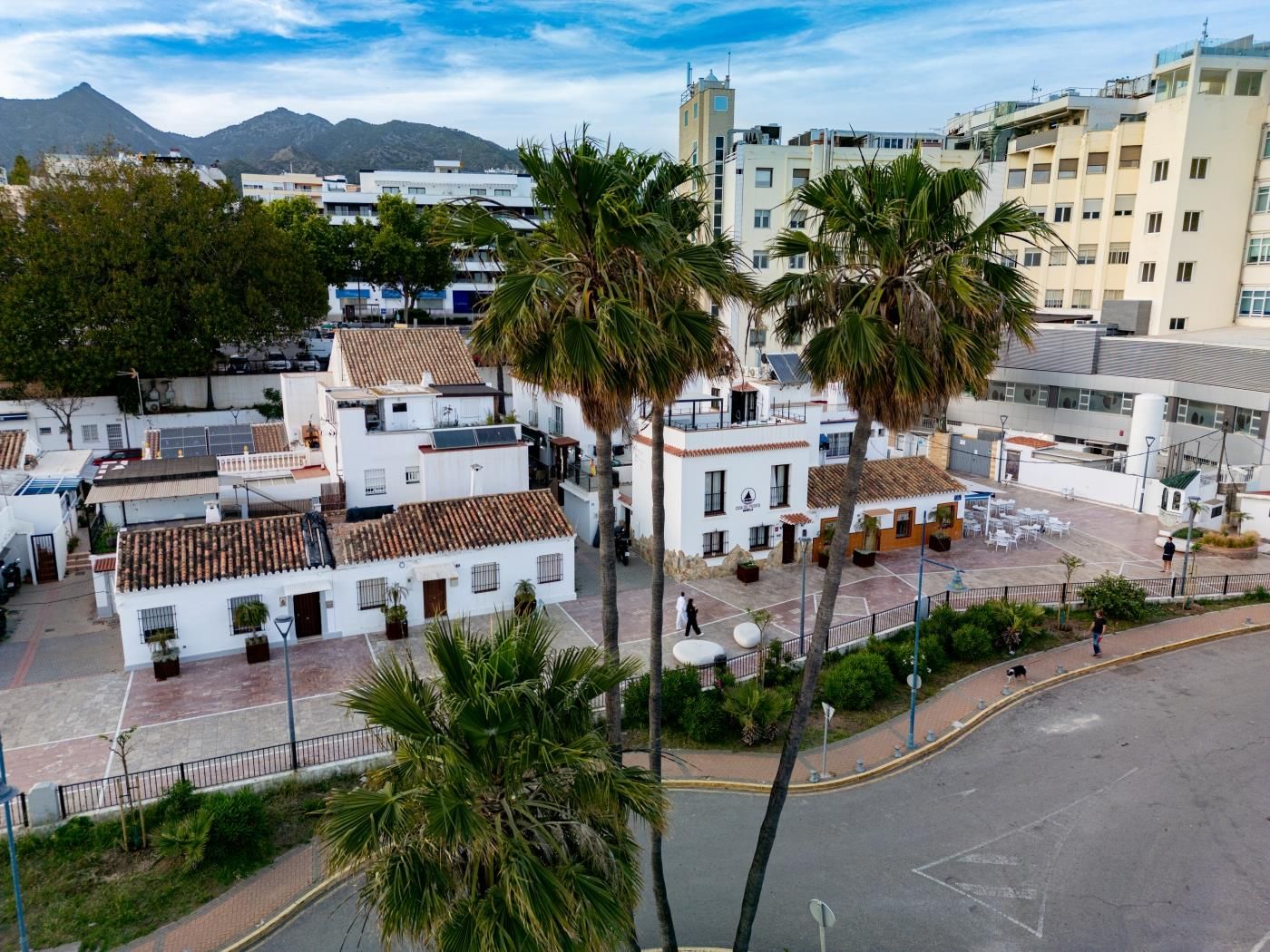 Elevated view over Casa del Puerto and the plaza, with Marbella's mountains behind
